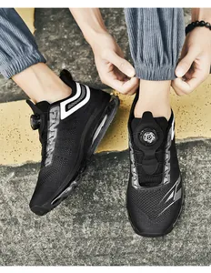 Detail view of black flyknit running shoes with rotary buckle and clear air cushion sole