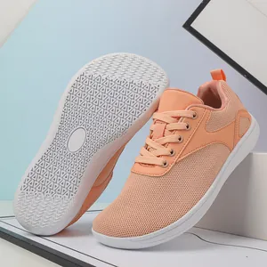 Detail of light orange mesh sneakers showing breathable fabric and wavy anti-slip rubber sole