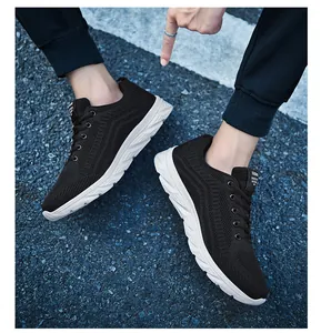 Close-up of black breathable mesh upper and durable white sole on men's running sneakers