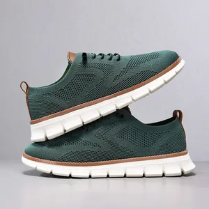 Detail of dark green breathable knit loafers for men with white soles and brown trim