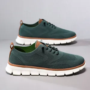 Detail of dark green breathable knit fabric sneakers with brown leather pull tabs and EVA sole
