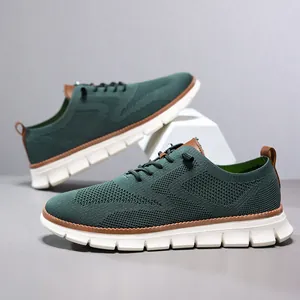 Detail of dark green breathable fly-knit men sneakers with leather accents and thick white sole