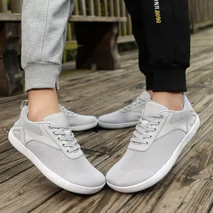Light grey breathable mesh sneakers for couples on a wooden path outdoor setting