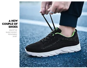 Detail of breathable black knit mesh running shoes with fluorescent green accents and laces