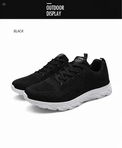 Detailed close-up of breathable black mesh fabric and sturdy laces on lightweight sports shoes
