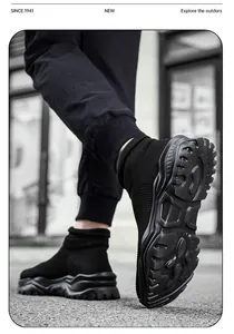 Detailed view of durable rubber outsole with slip-resistant patterns on black sock sneakers