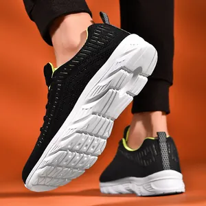 Detailed low angle view of wave-patterned non-slip sole on black breathable running shoes