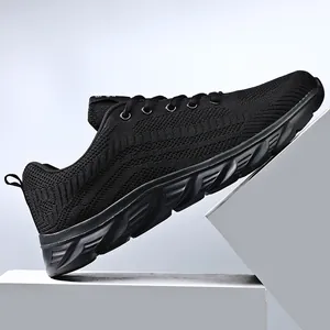 Detailed side view of breathable black knit mesh men's running shoes with wave pattern sole