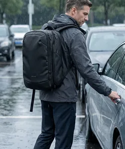 Water-resistant business backpack with DWR coating shown in heavy rain conditions
