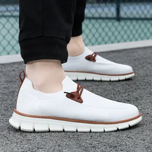 Detail of lightweight breathable white mesh loafers with brown lace accents on a male model
