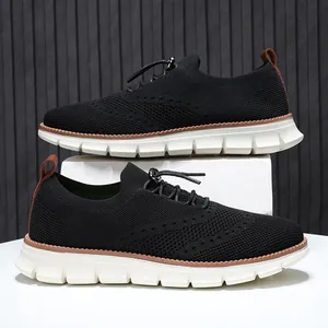 Macro view of breathable knit texture and reinforced lacing on casual black loafers