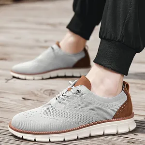 Detail of grey knitted loafers featuring brown leather accents and wavy white sole