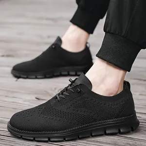 Macro detail of breathable knitted mesh and brogue patterns on black casual men's shoes