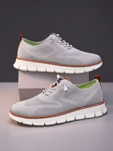 Close-up of gray breathable knit fabric and white non-slip sole on casual men's loafers
