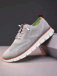 Macro detail of breathable grey flyknit mesh and lace-up design on casual men loafers