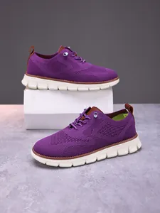 Close-up of purple breathable fly-knit mesh and brown leather details on men's loafers