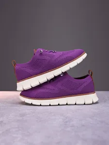 Close-up of purple breathable knit fabric and leather heel tab on men's casual loafers