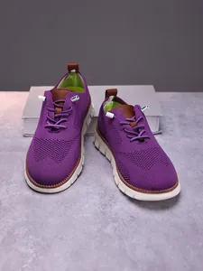 Detailed view of the breathable purple knit mesh upper and brown leather pull tabs on men loafers
