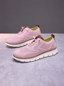 Macro detail of breathable pink knit fabric and thick white wavy anti-slip sole on men loafers