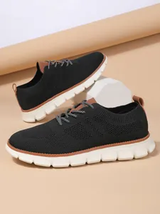Detailed shot of breathable black flyknit mesh material and brown leather accents on loafer