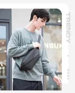 Close-up of black crossbody chest bag featuring minimalist geometric matte design