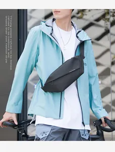 Men's matte black waterproof crossbody chest bag shown in outdoor cycling lifestyle scene