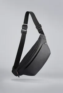Detail of waterproof black crossbody chest bag featuring premium textured fabric and hardware