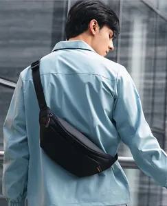 Waterproof black crossbody chest bag with orange stitching and nylon strap for outdoor