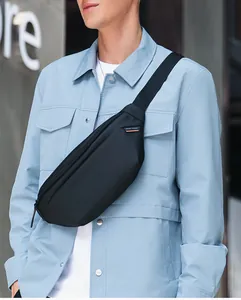 Close-up of waterproof nylon shoulder bag with Mark Ryden logo and orange strap detail