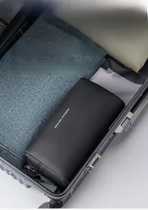 Macro view of portable black travel toiletry bag placed inside an organized luggage