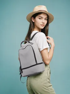 Gray lightweight casual backpack with black zipper trim shown in side view on model