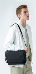 Waterproof black oxford messenger bag with adjustable strap and flap closure