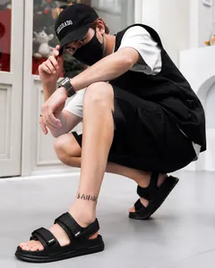 Detail of black men's sport sandals featuring double straps and a thick non-slip sole
