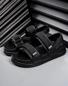 Close-up of black sports sandals with adjustable velcro straps and thick EVA cushioning sole