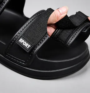 Detail showing adjustable Velcro strap and matte texture of the black sport sandal