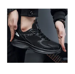 Detail of black breathable mesh sneakers with JGAK logo and thick cushioning sole