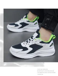 Close-up of blue mesh sneakers with green accents on a model wearing black joggers