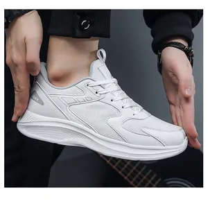 Close-up of white breathable mesh sneakers for men featuring JGAK logo and thick rubber soles