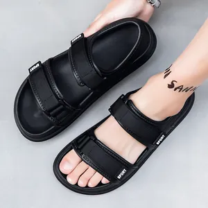 Detailed macro view of black sport sandals featuring adjustable Velcro straps and logo