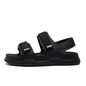 Detail of black sporty open-toe sandals with double velcro straps and thick EVA sole