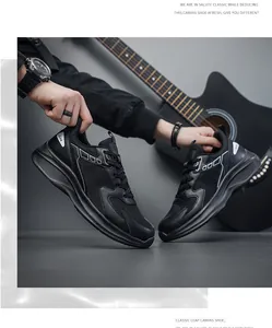 Detailed close-up of men's breathable black mesh sneakers with white geometric accents