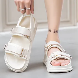Detail of cream white platform sport sandals with adjustable velcro straps and foam soles
