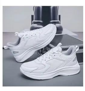 Detail of white sneakers showing breathable mesh panels and thick cushioned sole