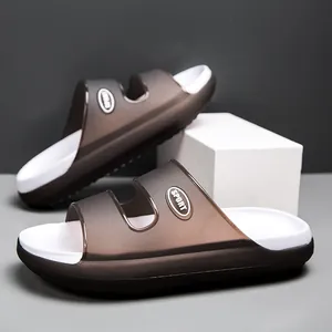 Detail of dark brown translucent slippers with white footbed and SPORT text logo