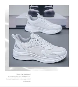 Detail view of white mesh sneakers with thick layered soles and JGAK logo on the side