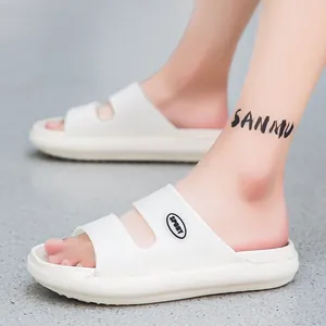 On-foot shot of white EVA slide sandals featuring a SPORT logo on the thick side straps
