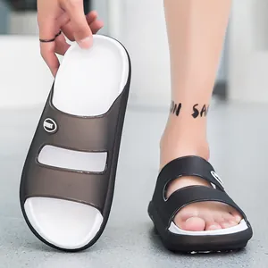 Detail view of sport slippers featuring black translucent shell and white anti-slip footbed