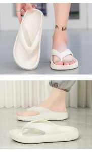 Close-up of thick EVA flip flops showing cushioned sole and cream finish in detail