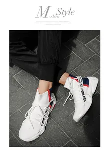 Close-up of high-top fly-knit sock sneakers with stylish letter webbing and thick sole