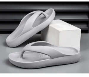 Detail view of grey EVA thick-soled flip flops with anti-slip textured footbed